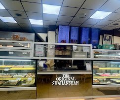 Inside Shahanshah: sweet and snack counters and the menu on the wall